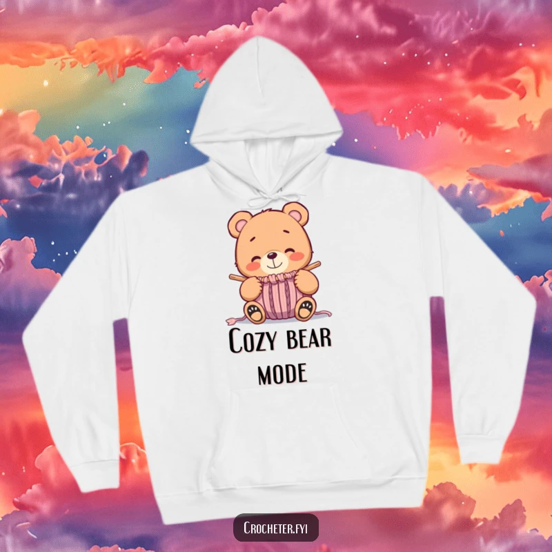 Funny whimsical bear smiling at a nearly finished knitted item, a warm and humorous hoodie for crafters.