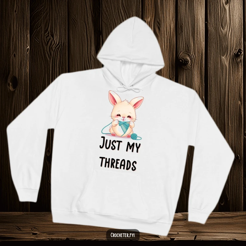 Funny bunny hoodie showing a fluffy rabbit intensely knitting a single, impossibly long thread, looking determined.
