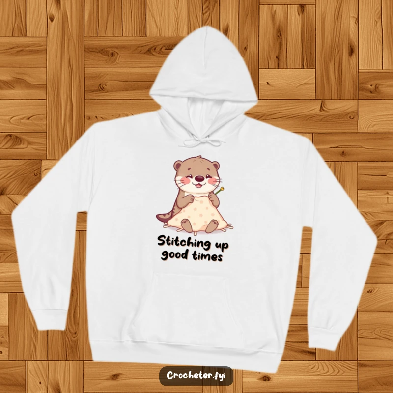 Funny Otter Stitching Hoodie: A happy otter attempts blanket making with oversized, clumsy needles, ideal funny gift apparel.