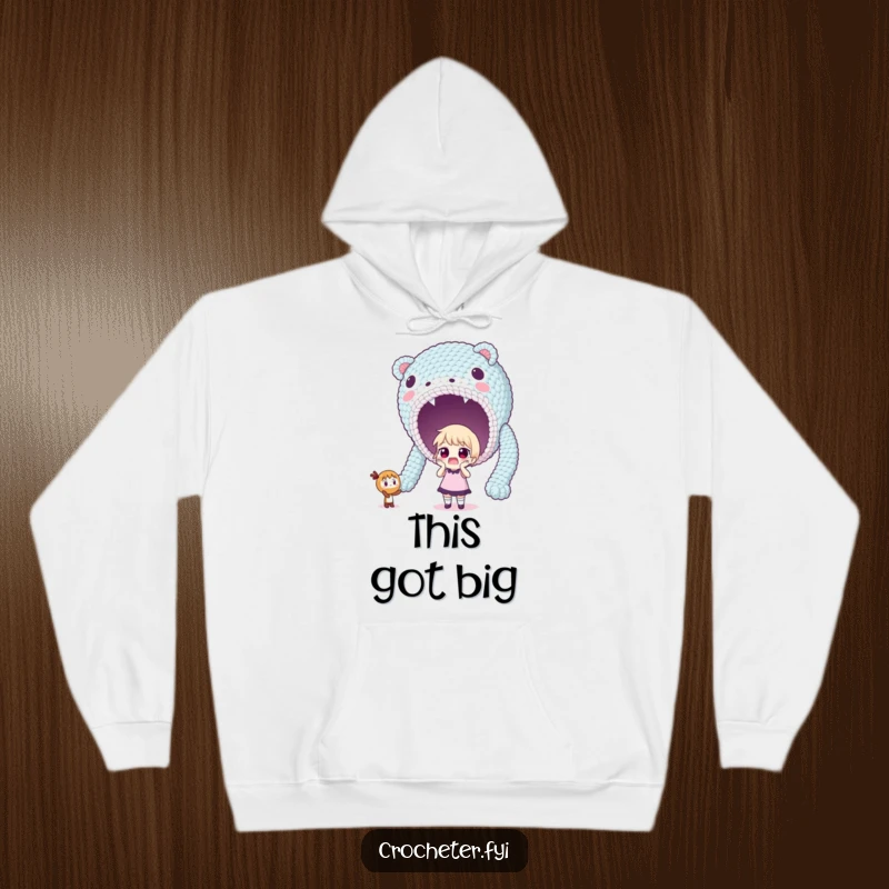 Funny hoodie showing a surprised character looking at a massive, unexpectedly large crocheted item, full of wonder.