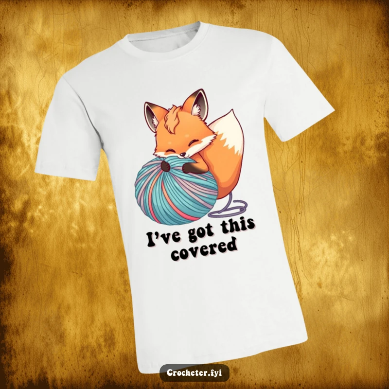 Funny T-shirt illustrating a fox comically unspooling an enormous ball of brightly colored yarn, exuding playful energy.