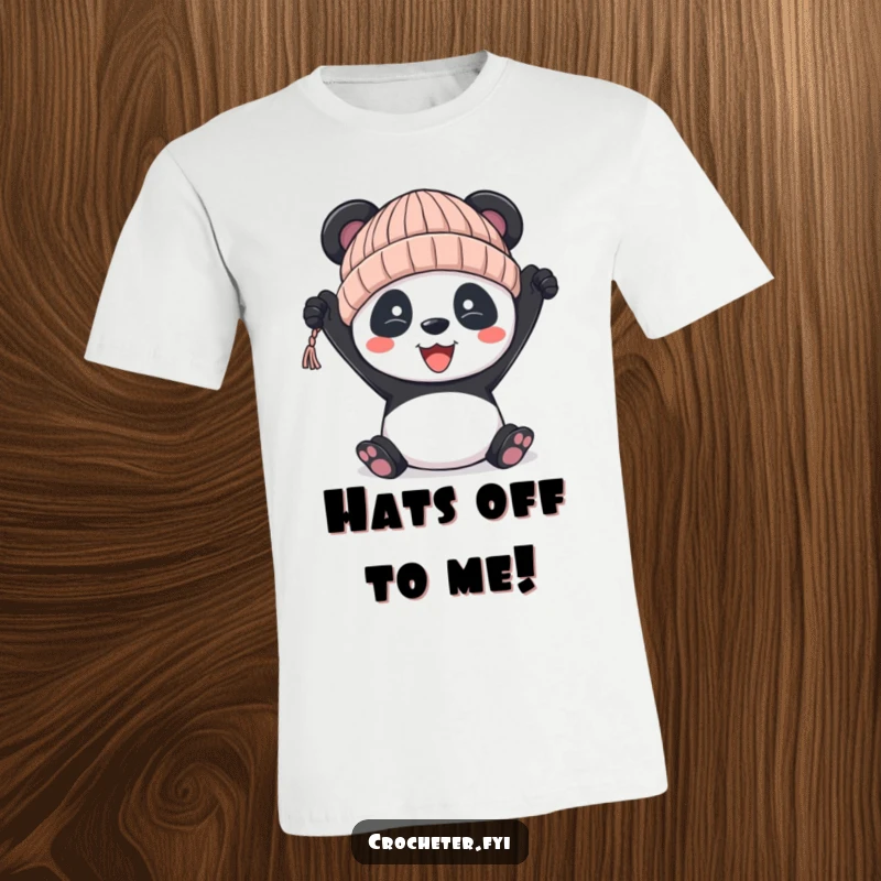 Funny panda t-shirt, showing a cheerful panda holding up a hand-knitted hat that’s a little bit wonky.