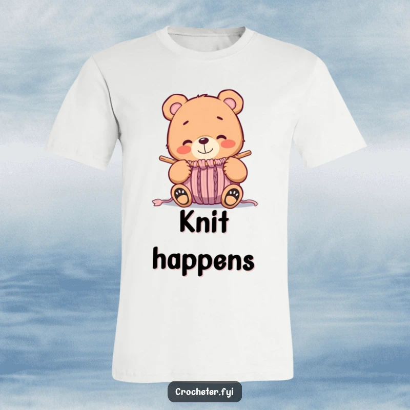 Funny whimsical bear smiling happily at a nearly finished knitted item, a cozy and humorous t-shirt.